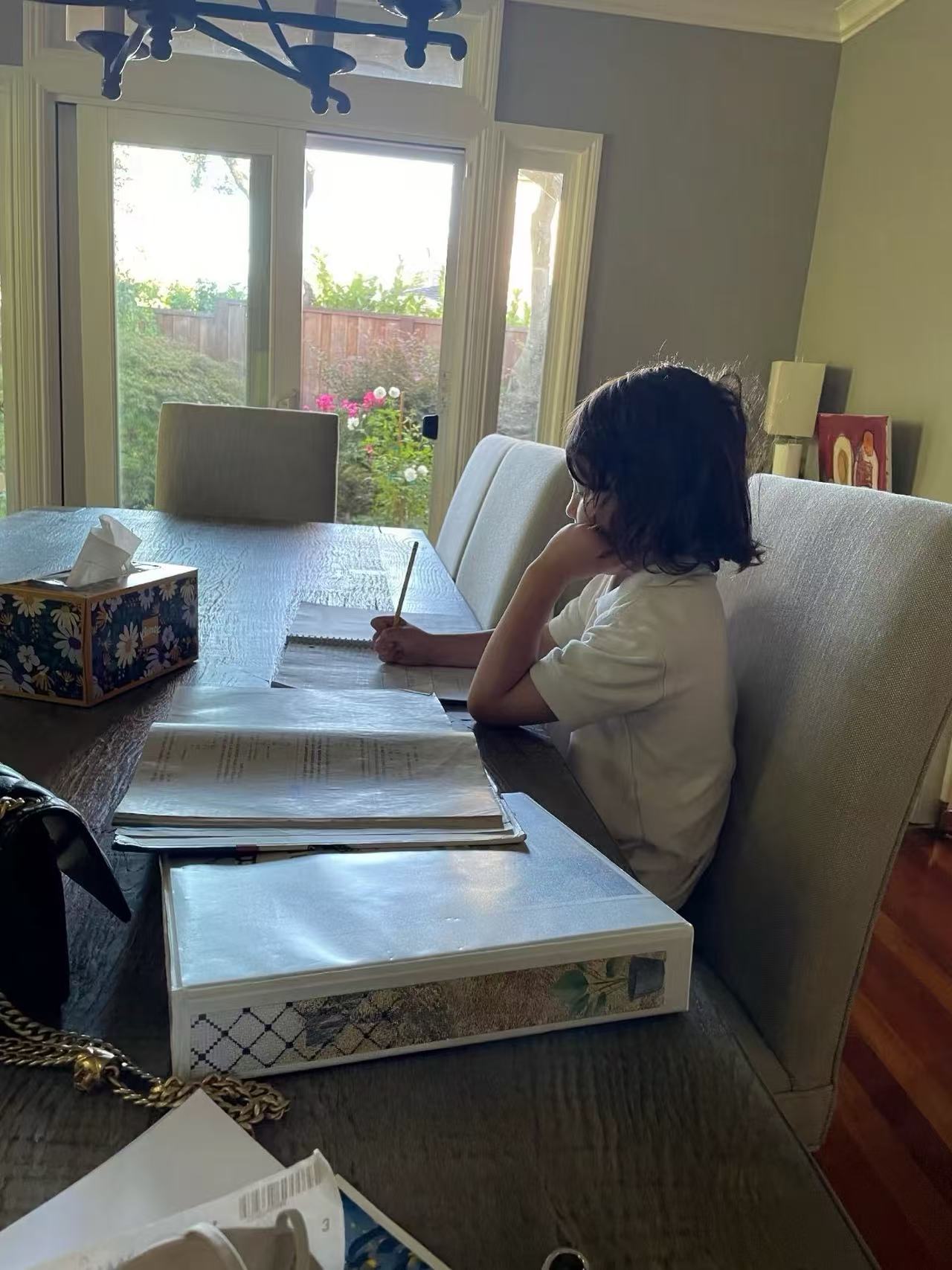 Child completing an activity with family support materials nearby