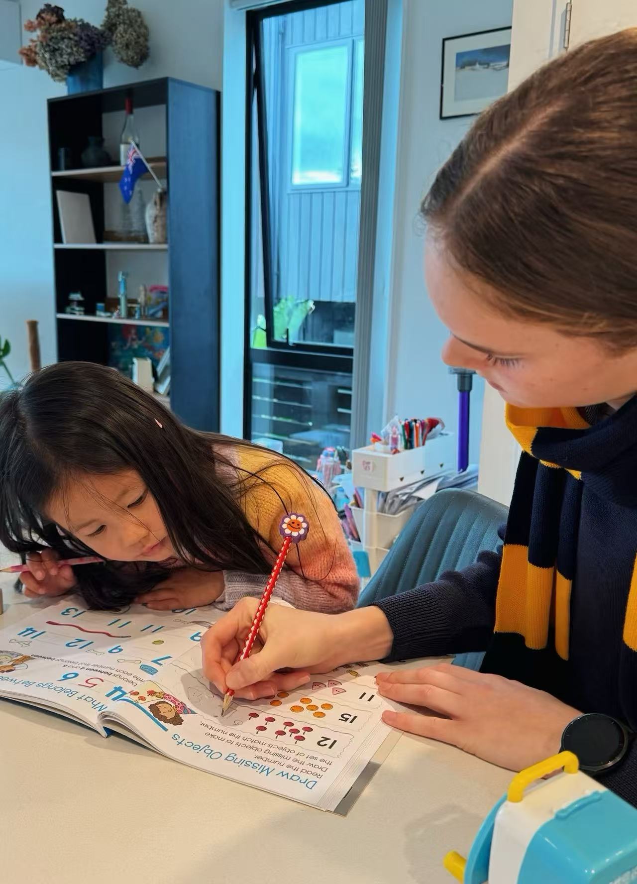 Youth participant working alongside a supportive program coordinator